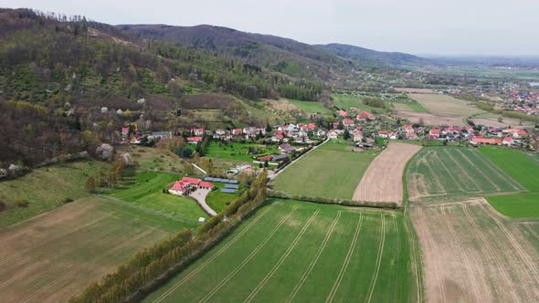 Mountain Village Among Green Fields Aerial View