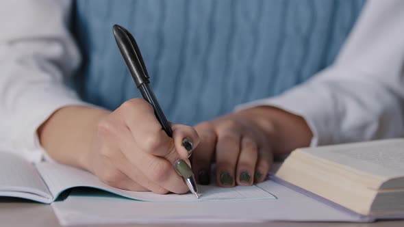 Closeup Female Hands Unknown Woman Student Sitting at Desk Studying Making Notes in Copybook