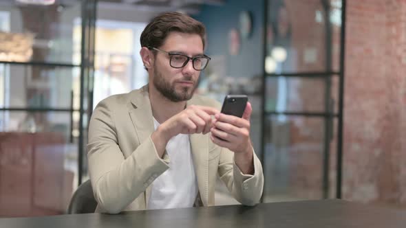 Attractive Young Man Using Smartphone