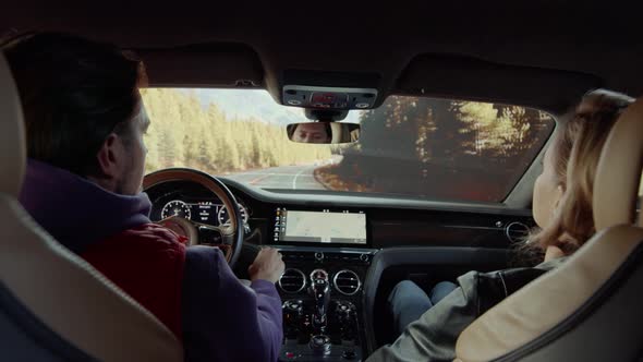 Man and woman in the front seat of a car