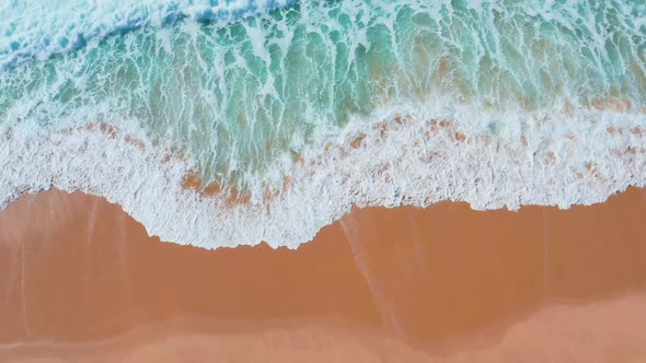 Low Flight Over the Sandy Beach and Waves