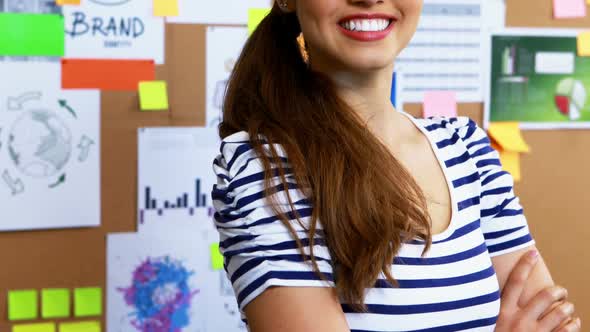 Portrait of female executive standing with arms crossed