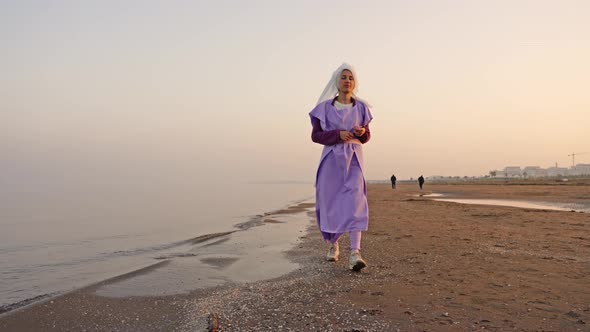 Proud Woman Approaches Easel with Bright Seascape on Beach