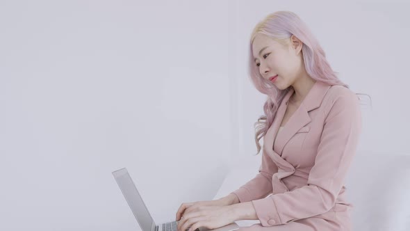 Asian secretary woman happy work from home on laptop