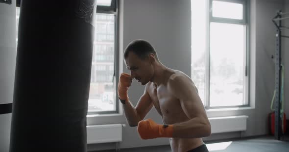 Mixed Martial Arts Fighter Kicks Boxer Bag in Slow Motion Fighter is Training in Boxing Club 120p