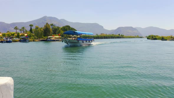 Amazing Landscape on the River Dalyan, Turkey. Sailing Past the Tourist Boat. Reeds and Mountains