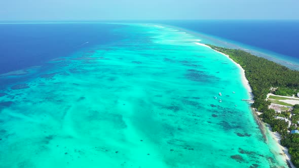 Wide angle overhead tourism shot of a sandy white paradise beach and aqua turquoise water background