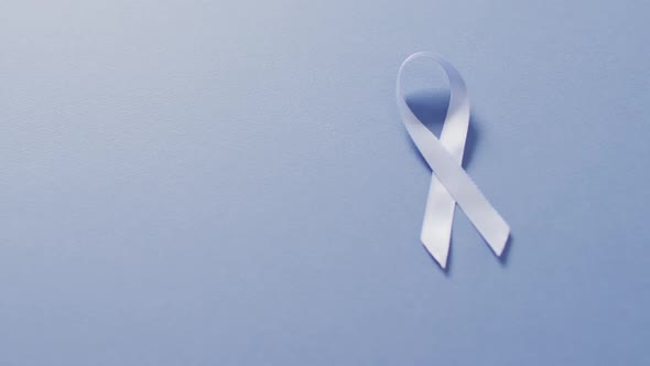 Video of pale blue prostate cancer ribbon on blue background