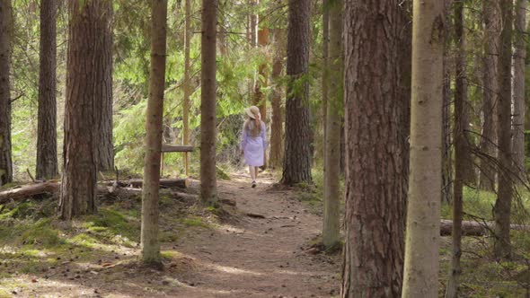 Spiritless bored maid searching for unexplored places in Danish woods