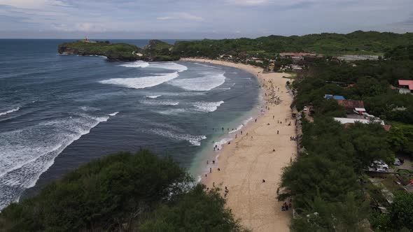 People play in Beautiful beach in Gunung Kidul, Indonesia