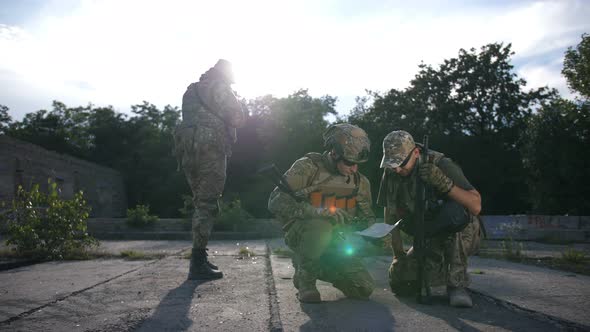 Soldiers Looking at Map During Military Operation