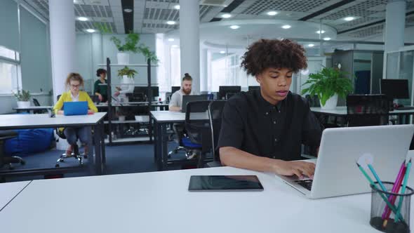 African American Manager Working in Office