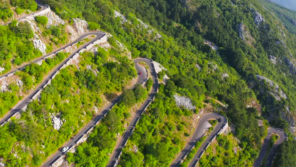 Aerial Top View on Curvy Serpentine Road on Kotor Bay Montenegro