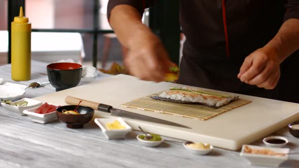 Hands of Cook Make Sushi.