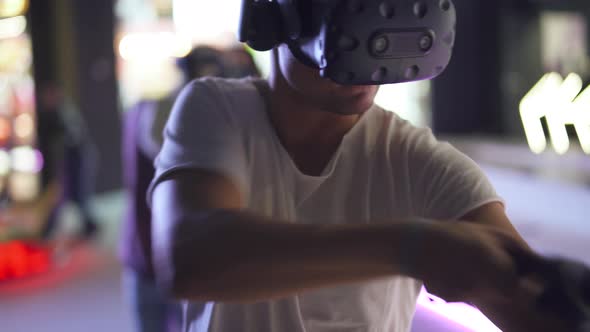 Modern Interactive Technologies, Man in Glasses of Virtual Reality Playing a Arcade Game, a Man