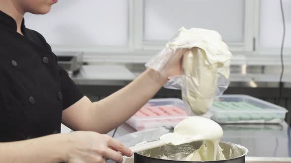 Cropped Shot of a Confectioner Putting Sour Cream Into Pastry Bag