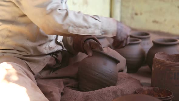 Indian man shaping clay in workshop in Mumbai.