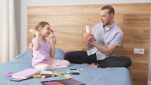 Little Girl Show New Cosmetics at Phone's Camera