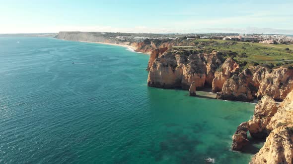 Panoramic view sea, coast and cliffs of Lagos in Algarve, Portugal. Aerial forward