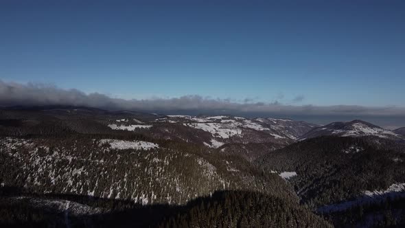 Aerial Shot from Above the Mountains in Winter Season with Blue Clear Sky, Drone Video