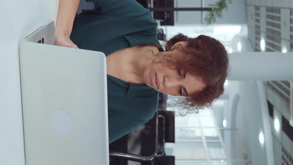 Vertical Screen Black Woman Using Laptop in Coworking Space