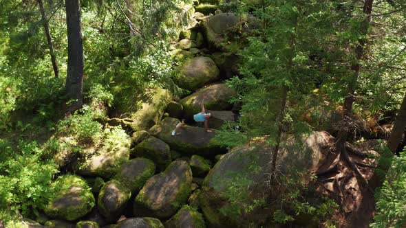 A Girl Practices Balance and Yoga in the Forest