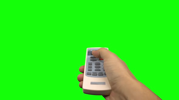 Hand Pushing Temperature Button on Air Conditioner Remote Control. Green Screen