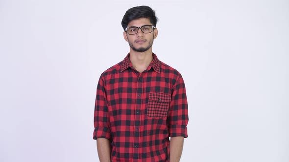 Young Handsome Bearded Indian Hipster Man Wearing Eyeglasses