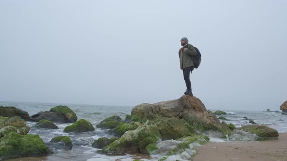 One Lone Tourist in the Wilderness with Stone Mountains and Coast