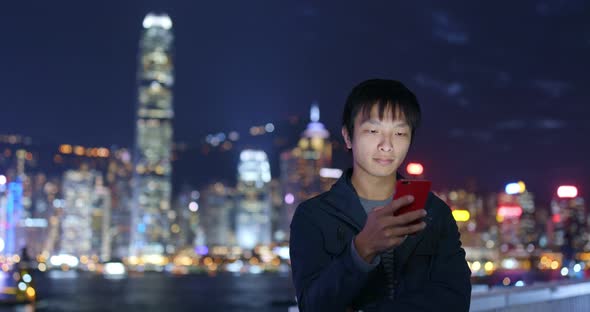 Man use of smart phone in Hong Kong at night