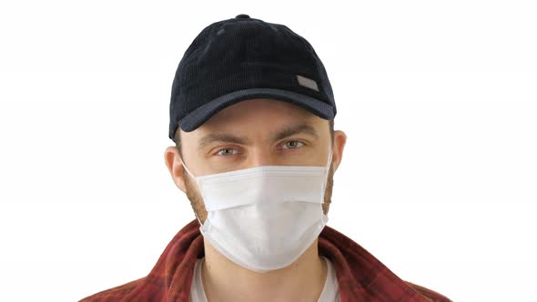 Caucasian Man Wearing a Protection Mask Making Ok Sign on White Background.