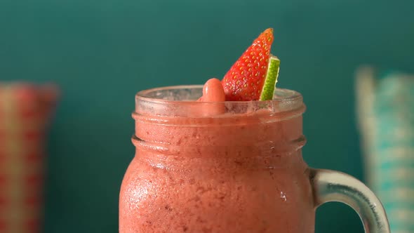 Fresh Tropical Organic Strawberry Smoothie Rotate on Table.