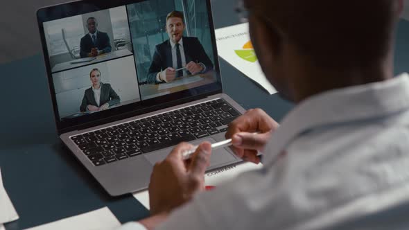 Young businessman makes conference video call on laptop computer