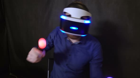 Man in Helmet Virtual Reality Closeup, Game Console Play Boxing and Wins 