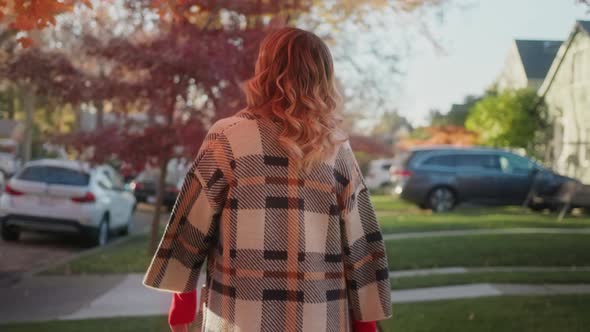 Stylish Woman Walking in the Neighborhood and Enjoying Beautiful Autumn Nature