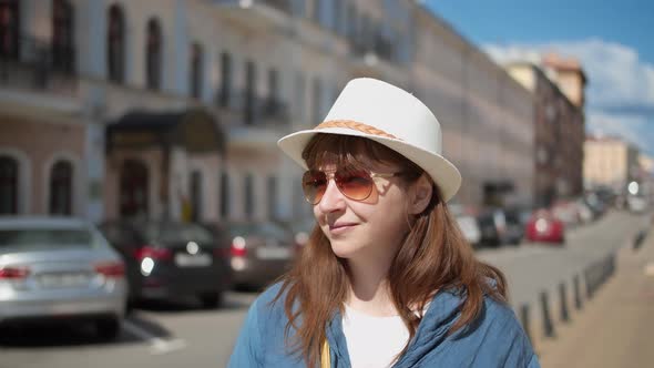 Happy Travel Woman in Hat Walking Through the City Woman Walking Down the Street and Smiling