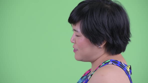 Closeup Profile View of Happy Young Overweight Asian Woman Talking Ready To Party