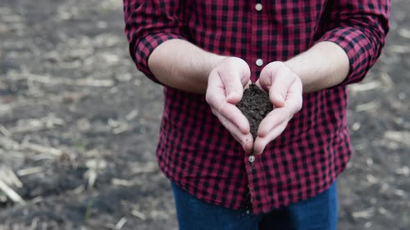 Farmer Hand with Fertile Soil
