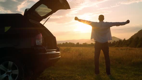 Casual Man Stretching at Sunset