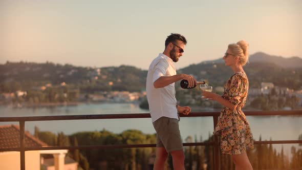 Joyful Happy Romantic Affectionate Family. Romantic Couple Open Champagne At Sunset.Honeymoon Lovers