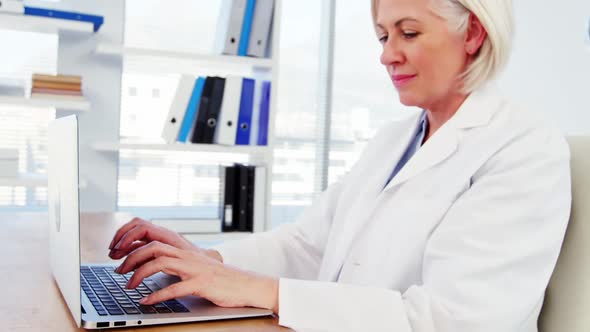 Female doctor working over laptop