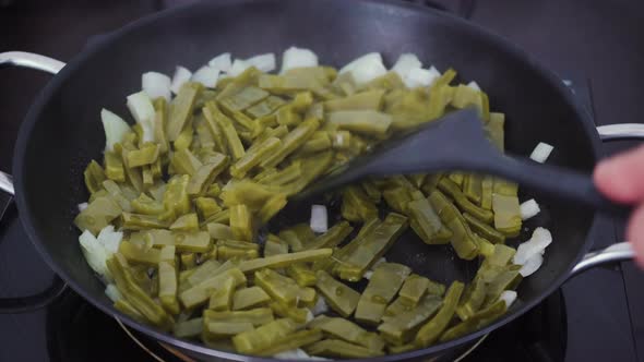 Cactus food being fried with onions by cook. A traditional native Mexican cuisine and street food al