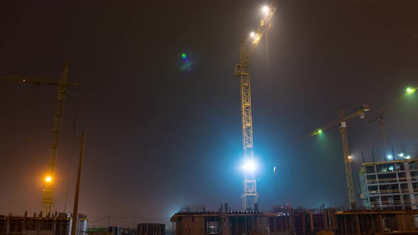 Construction site with crane night time lapse. Building of skyscrapers.