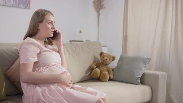 Pregnant Woman Talking On Phone