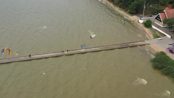 AERIAL: A Kiteboarder Harnessesed the Power of the Wind and Jumps Over Stone Pier