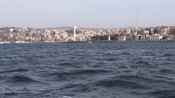 View From A Boat Sailing At Bosphorus With City Buildings And Towers At Uskudar, Istanbul, Turkey. -