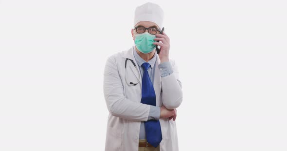 Senior Doctor Talking on Smartphone on White Background.slowmotion, 6K.