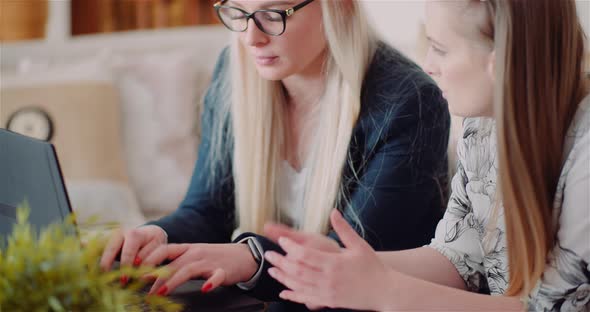 Female Colleagues Discussing Business Strategy In Office