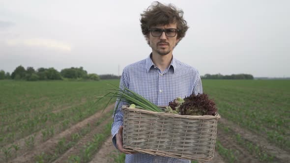 The Farmer is Holding a Box of Organic Vegetables