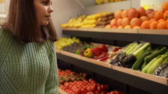 Young Woman with Shopping Cart in Grocery Store